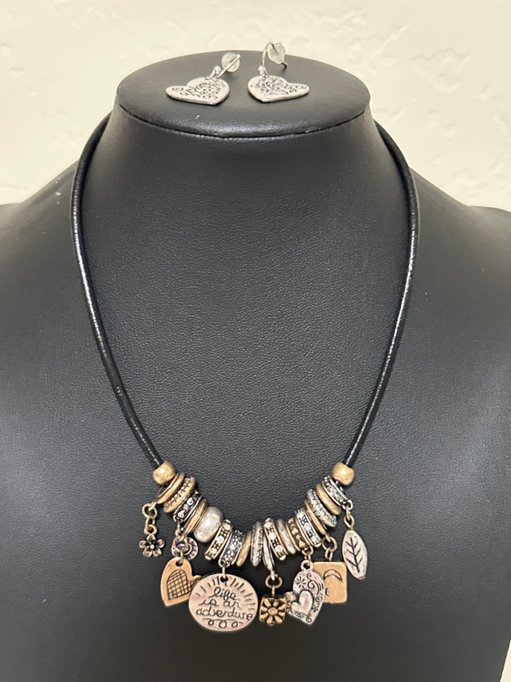 40.  Floating Silver Tone & Gold Tone Charms Black Cord Necklace & Earring Set